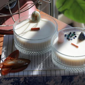 Two exquisite homemade candles decorated with artistic elements, perfect for home decor inspiration.